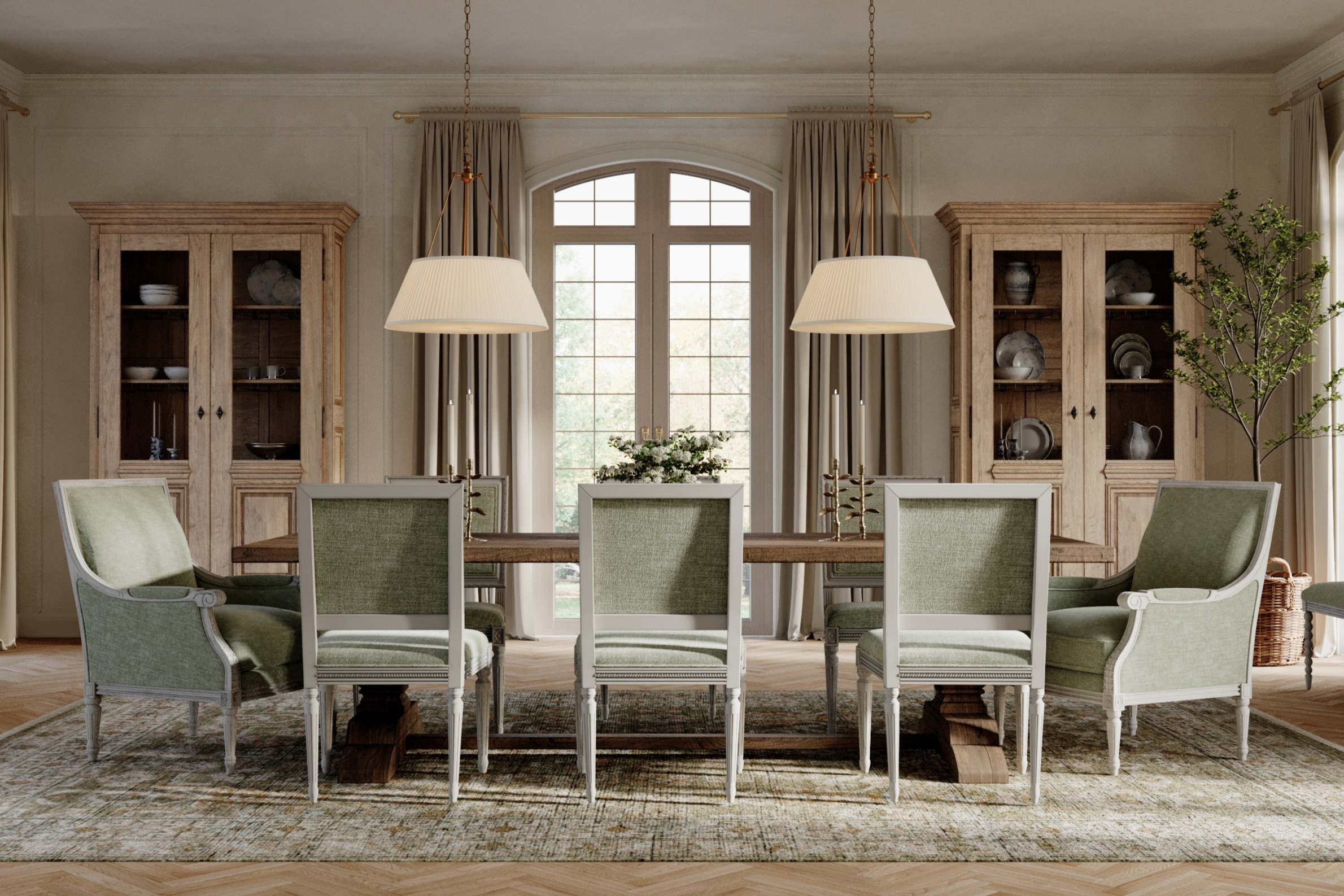 An elegant dining room with green upholstered chairs, pendant lights, an oak dining table, and a set of china cabinets