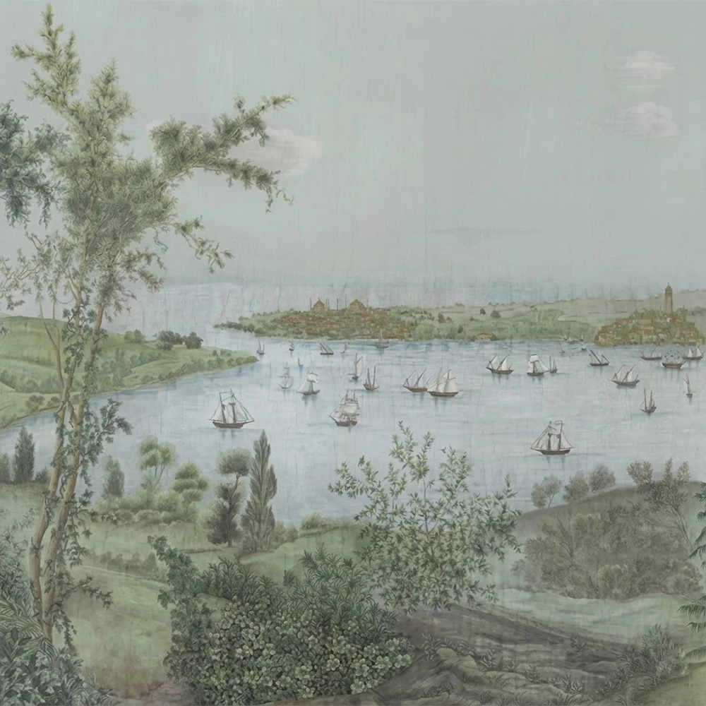 blue and green mural wallpaper that shows rolling hills leading to a lake with sailboats on it