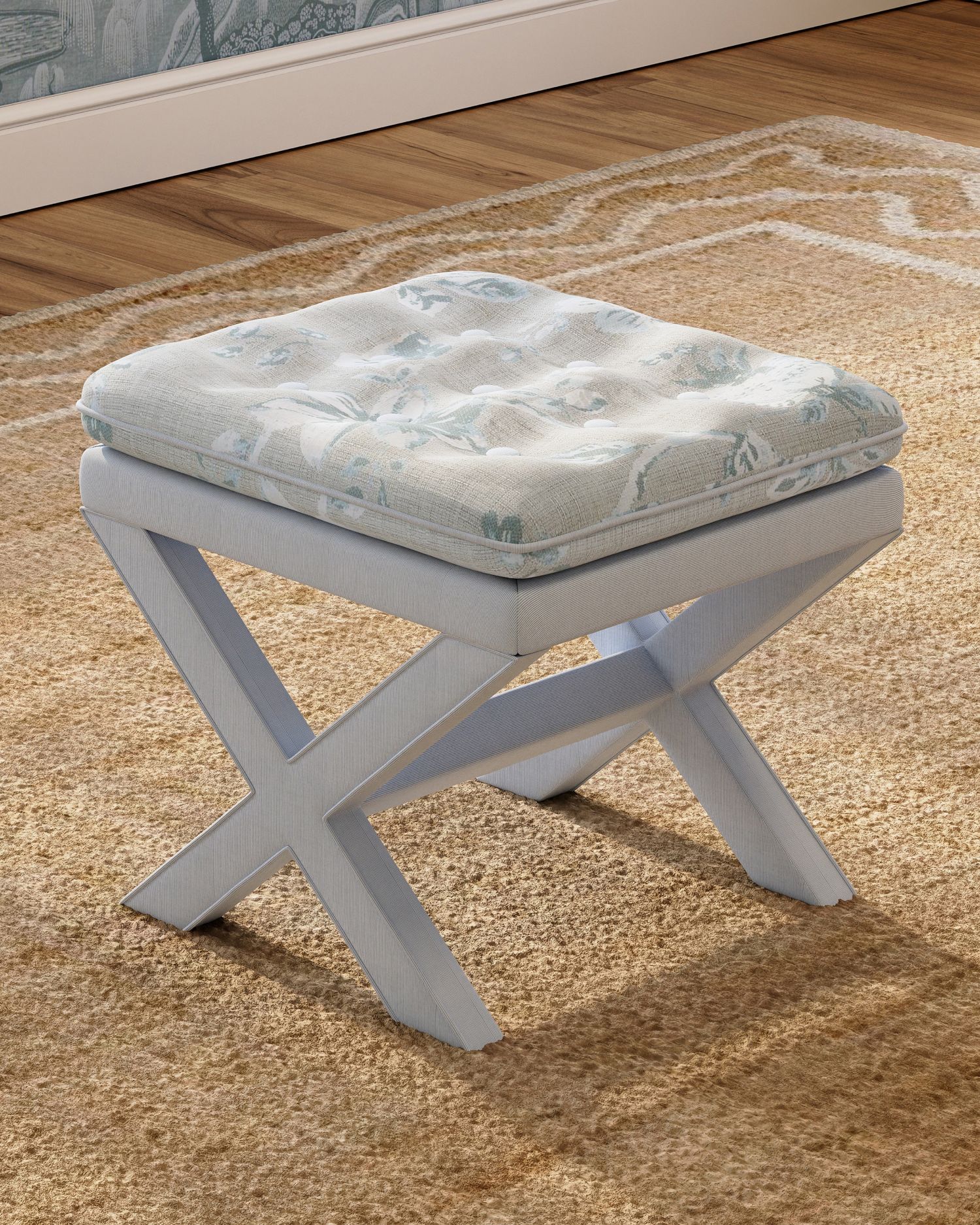 an x-base stool with striped upholstered legs and a botanical tufted cushion